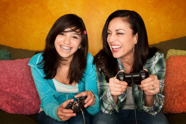 Mom and Daughter Smiling Playing Video Games