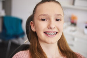 Portrait of smiling child with braces in orthodontist's office